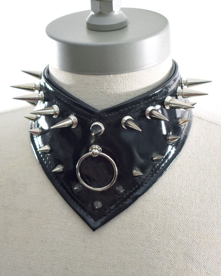 "This product is a handmade choker, created from faux leather/vegan leather. The Gorget Choker stands at 3.5\" inches in height, and it is our first choker to come to a point in the center front. All metal accessories are made of stainless steel (spikes, rivets, D-rings, chain, lobster claw). Sizes are adjustable: X Small: 12-14 inches Small: 14-16 inches Medium: 16-18 inches Large: 18-20 inches" Masc Goth, Holographic Choker, Rings Chain, Emo Stuff, Alt Clothes, Goth Accessories, Handmade Chokers, Black And White Shirt, Punk Outfits