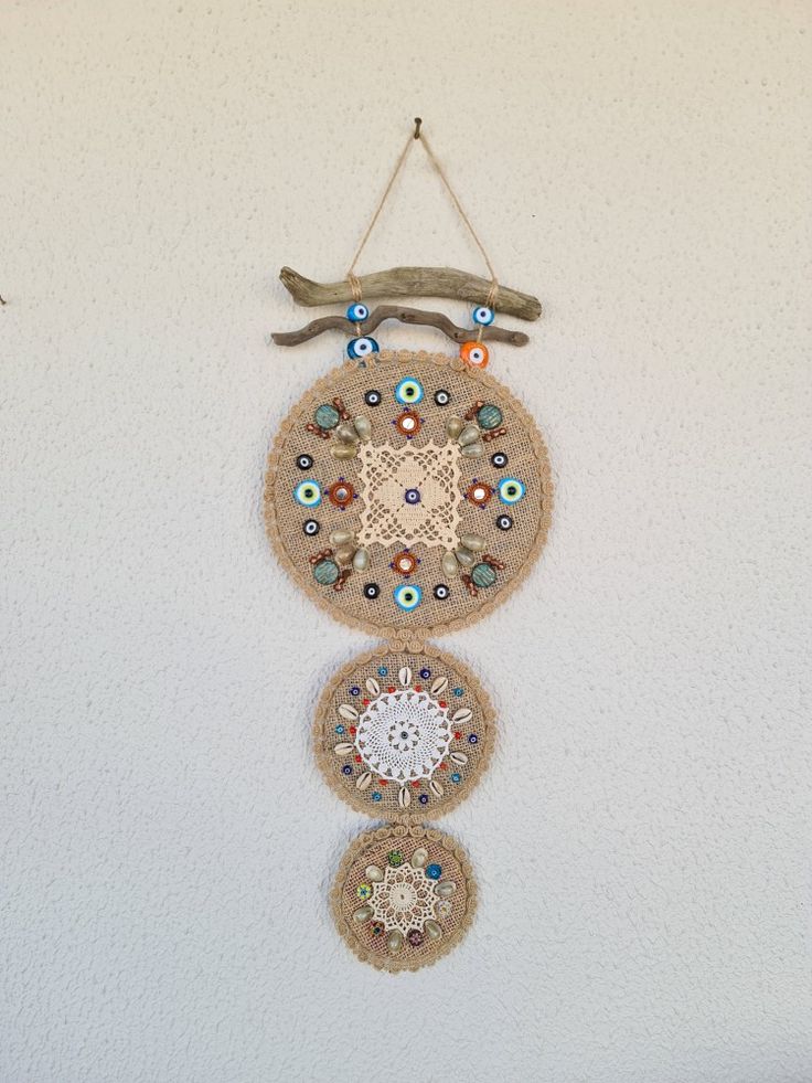 there is a wall hanging made out of burlocks and beads on the wall