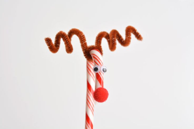 a candy cane decorated like a santa clause with a red nose and nose on it