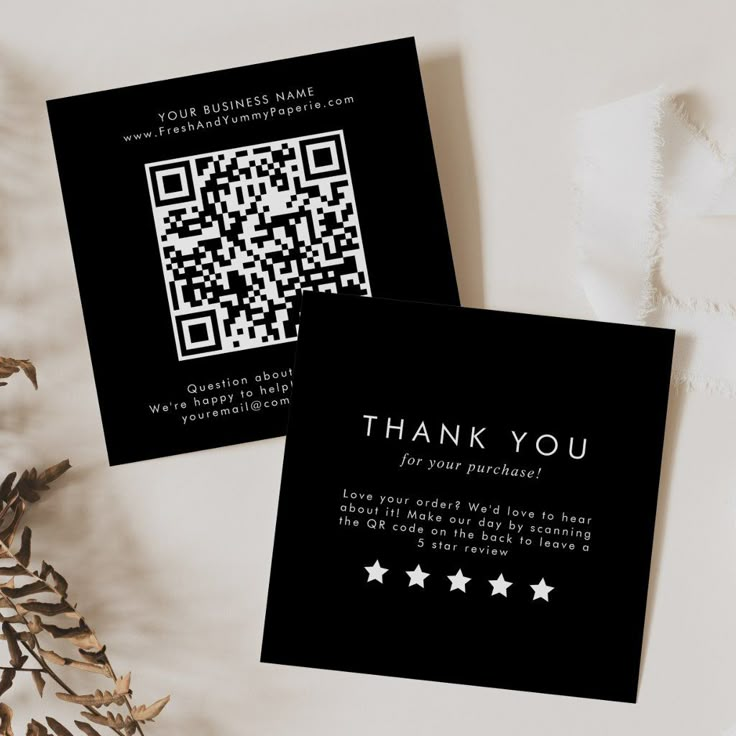 two black business cards with white stars and the words thank you written on one side