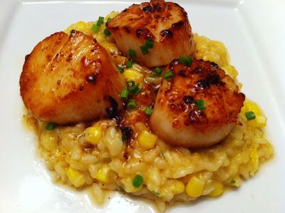 some scallops and corn on a white plate