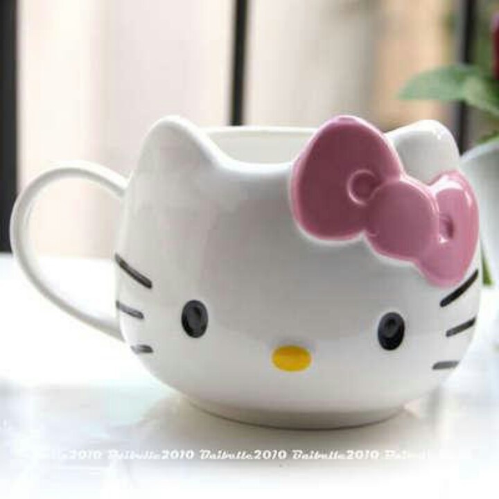 a hello kitty mug sitting on top of a table