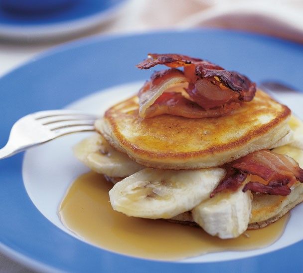 pancakes with bacon and syrup on a blue plate