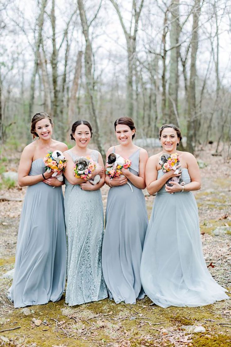 four bridesmaids pose for a photo in the woods