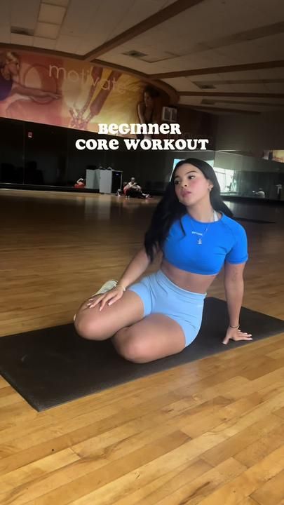 a woman sitting on top of a yoga mat