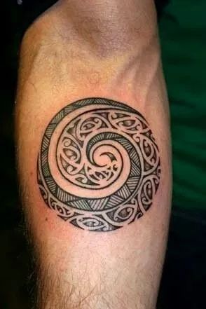 a man's arm with a tattoo on it that looks like a spiral design