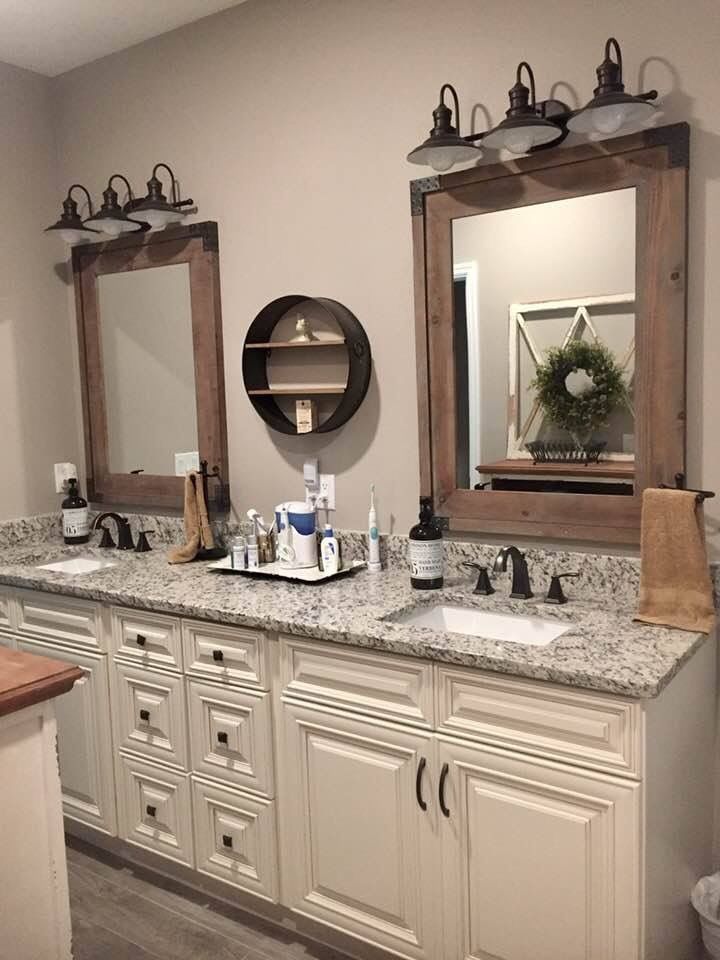 a bathroom with two sinks and mirrors in it