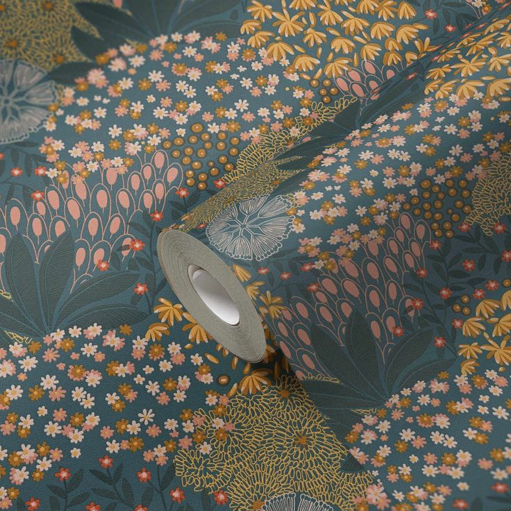 a roll of tape sitting on top of a floral wallpaper