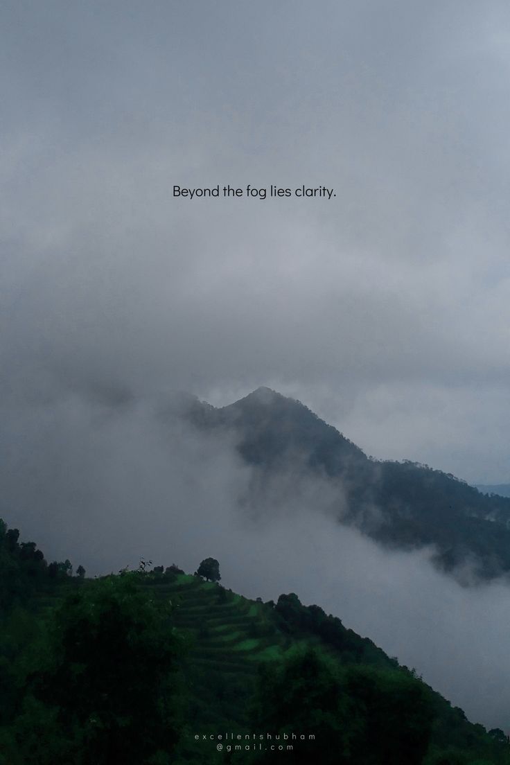 the mountains are covered in fog and clouds with words above them that read beyond the fog lies clumpy