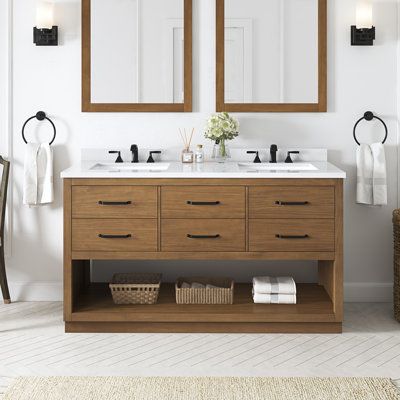 a bathroom vanity with two mirrors above it and a rug on the floor next to it