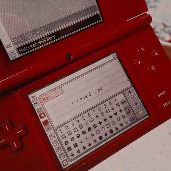 a red electronic device sitting on top of a table