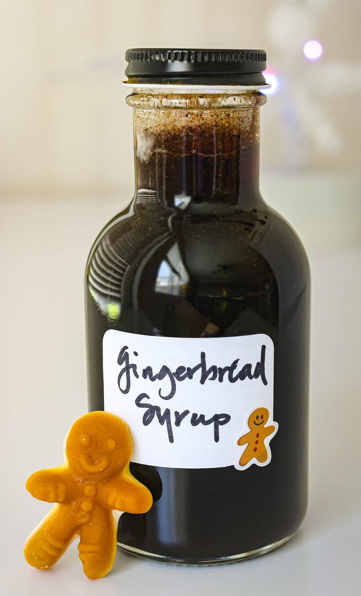 a gingerbread syrup in a glass jar next to an orange teddy bear with a sign on it