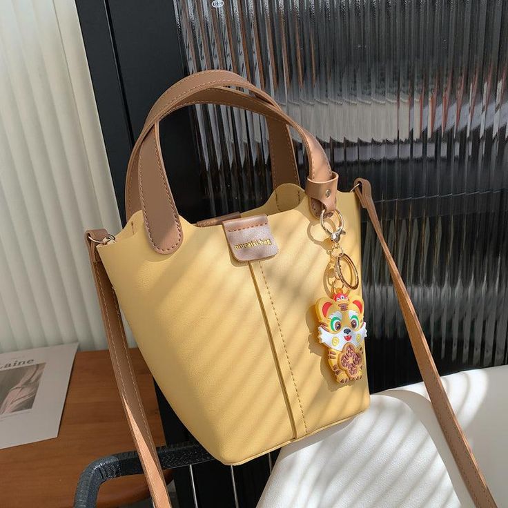 Material: PU Texture: Soft Closed: Buckle Size: 5.1"L x 5.1"W x 6.7"H in; It is enough to hold daily stuffs including cell phones, sunglasses, wallet, key etc. Baldric: Adjustable shoulder strap Portable Crossbody Bucket Bag For Shopping, Trendy Rectangular Bucket Bag, Trendy Rectangular Portable Bucket Bag, Yellow Phone Bag With Removable Pouch As Shoulder Bag, Everyday Yellow Phone Bag With Adjustable Strap, Portable Yellow Phone Bag For Everyday Use, Trendy Portable Crossbody Bucket Bag, Trendy Crossbody Bucket Bag, Yellow Shoulder Phone Bag For Everyday Use