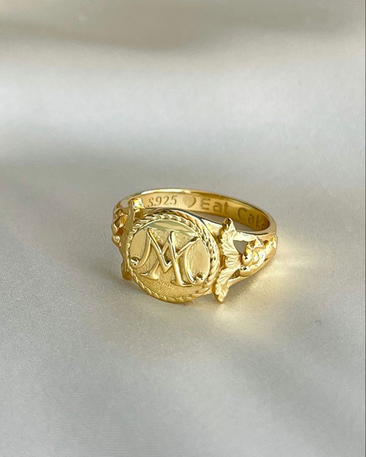 The Marie Antoinette Ring her monogrammed rIng MA, she was the queen of France brfore the French Revolution. This beautiful ring made of 18k gold plated silver and inscribed inside Eat Cake. Wedding Initial Ring With Round Band, Gold Oval Initial Ring Stamped 14k, Timeless Open Initial Ring As Gift, Gold Sterling Silver Engraved Open Ring, Gold-color Open Ring Engraved Sterling Silver, Gold-color Sterling Silver Engraved Open Ring, Gold Heirloom Dome Ring Hallmarked, Gold-colored Sterling Silver Engraved Open Ring, Heirloom Gold Dome Ring Hallmarked