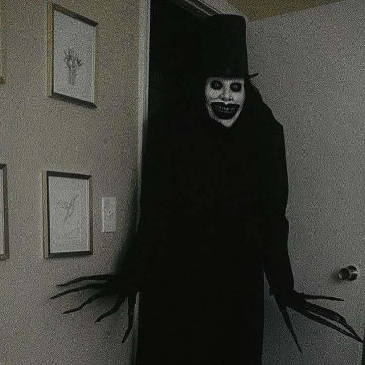 a person in a creepy costume standing by a door