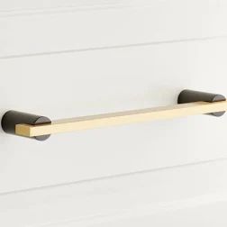 two black and gold towel bars on a white wall