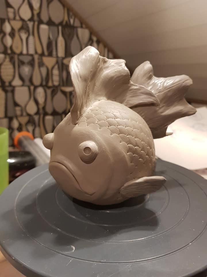 a ceramic fish sitting on top of a table