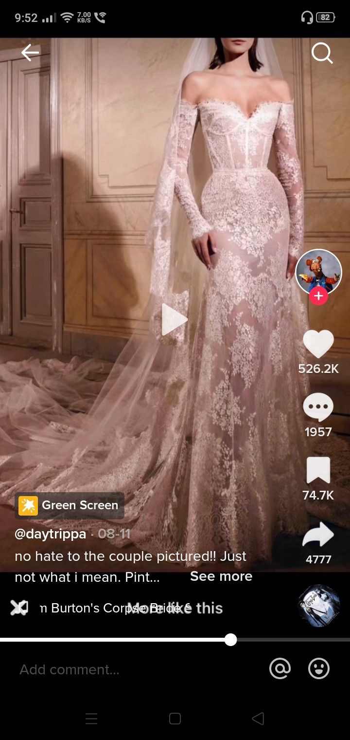 a woman in a wedding dress on the app store's mobile page, showing off her long sleeves