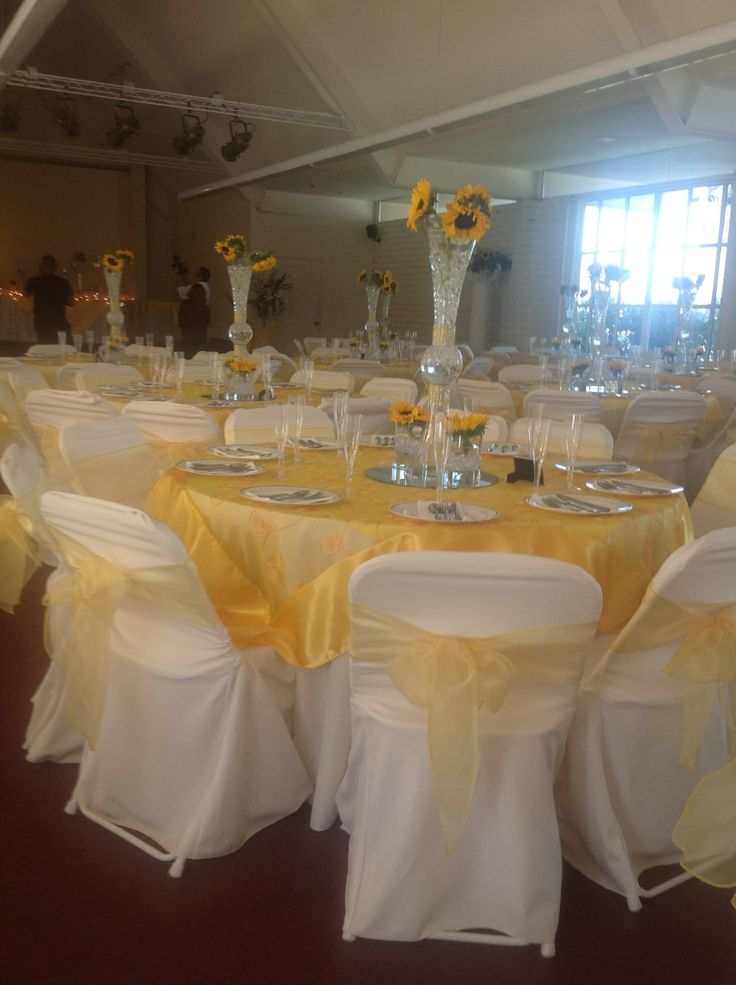 the tables are set with yellow and white linens