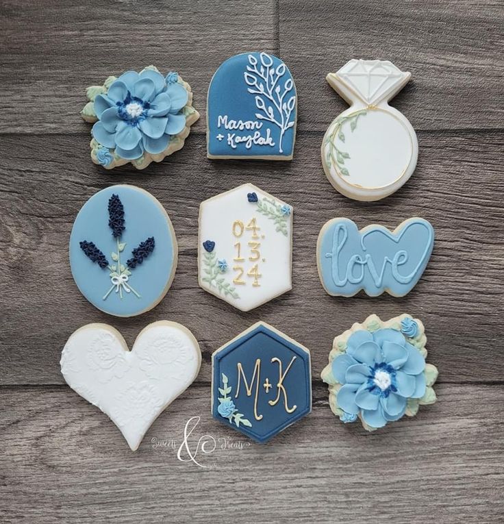 decorated cookies are arranged on a wooden table