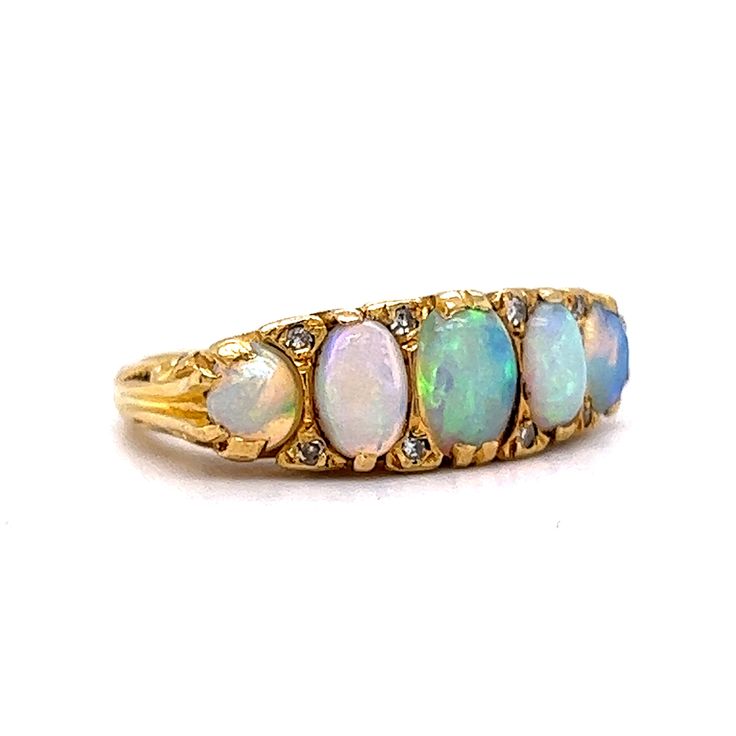 This antique Victorian era ring boasts an antique feel that will transport you to a time of glamour and luxury. Crafted from 18 karat yellow gold, this ring features beautiful cabochon opals as the primary stones and are set across the entirety of the band. The opals are complemented by eight diamonds, adding a hint of sparkle. Its timeless beauty and exceptional quality make it the perfect addition to any jewelry collection. Whether you're looking for a statement piece for a special occasion or Victorian Yellow Gold Cabochon Jewelry, Luxury Victorian Gold Opal Ring, Victorian Yellow Gold Opal Jewelry, Victorian Yellow Gold Opal Cabochon Ring, Victorian Cabochon Opal Ring Collectible, Metal Shop, Shop Engagement Rings, Opal Ring, Antique Victorian