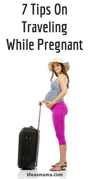 a pregnant woman with a suitcase posing for the camera