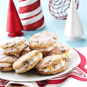 cookies with white frosting and chocolate chips on a plate