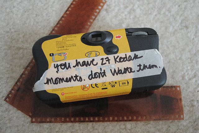 a cell phone with a message written on it sitting on top of a piece of cardboard