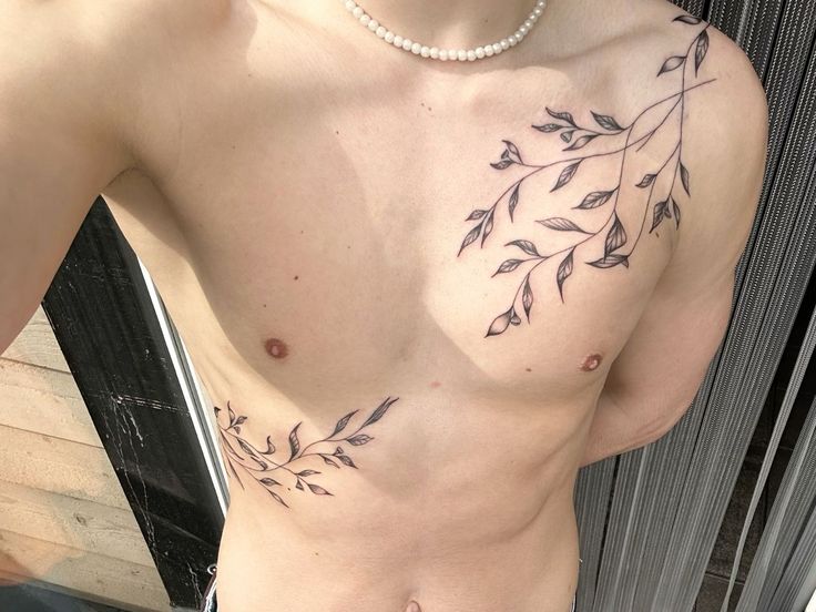 a man with no shirt has tattoos on his chest