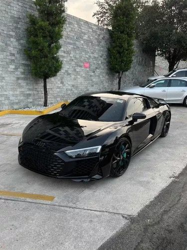 a black sports car is parked in the parking lot