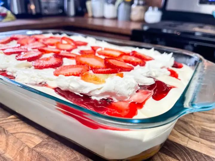 a dish with strawberries and whipped cream in it