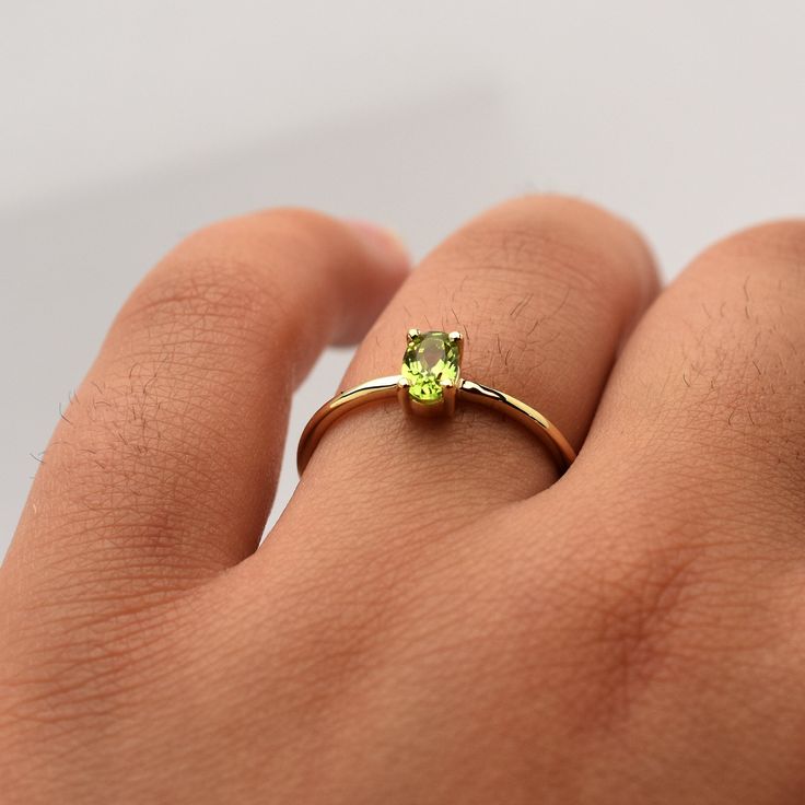 Peridot Ring / 14k Gold Peridot Ring / Oval Peridot Solitaire Ring / Peridot Birthstone Ring / August Birthday Peridot / Stackable Peridot   free shipping  within the USA AUGUST BIRTHSTONE  HANDMADE AND HANDSET GORGEOUS GREEN 6 by 4 MM OVAL PERIDOT PRONG SET IN 14K SOLID YELLOW GOLD.  I MAKE THIS RING IN ALL RING SIZES AND ALL 14K GOLD COLORS.  IF THERE IS A SIZE THAT YOU DO NOT SEE PLEASE LEAVE ME A NOTE AT TIME OF PURCHASE AND I WILL MAKE IT FOR YOU. METAL: 14K YELLOW GOLD 585 STONES: GENUINE 6 BY 4 MM OVAL PERIDOT STYLE: AUGUST BIRTHSTONE RING PURITY: 14K, 585 SIZE: 6 BY 4 MM OVAL PERIDOT/ SHANK OF RING  IS 1.2MM AS IT IS WITH THIS ITEM ALL MY PIECES ARE HAND MADE. AND I STAND BEHIND EVERY PIECE. SATISFACTION GUARANTEED. FIND OUT ABOUT OUR LAYAWAY PAYMENT PLAN AND HASSLE FREE RETURNS  I Yellow Gold Peridot Birthstone Ring, Green Sapphire Ring In 14k Gold, Green Oval Sapphire Ring In 14k Gold, Oval Green Sapphire Ring In 14k Gold, Dainty Green Oval Birthstone Ring, Yellow Gold Peridot Solitaire Birthstone Ring, Peridot Rings In Yellow Gold For Promise, Yellow Gold Peridot Promise Ring, Yellow Gold Peridot Rings For Promise