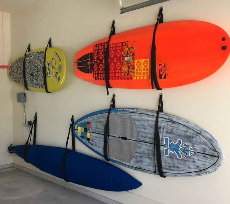 three surfboards are hanging on the wall