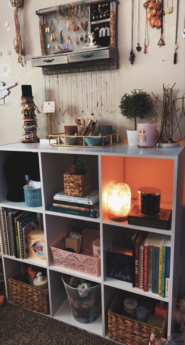 a book shelf with baskets and other items on it