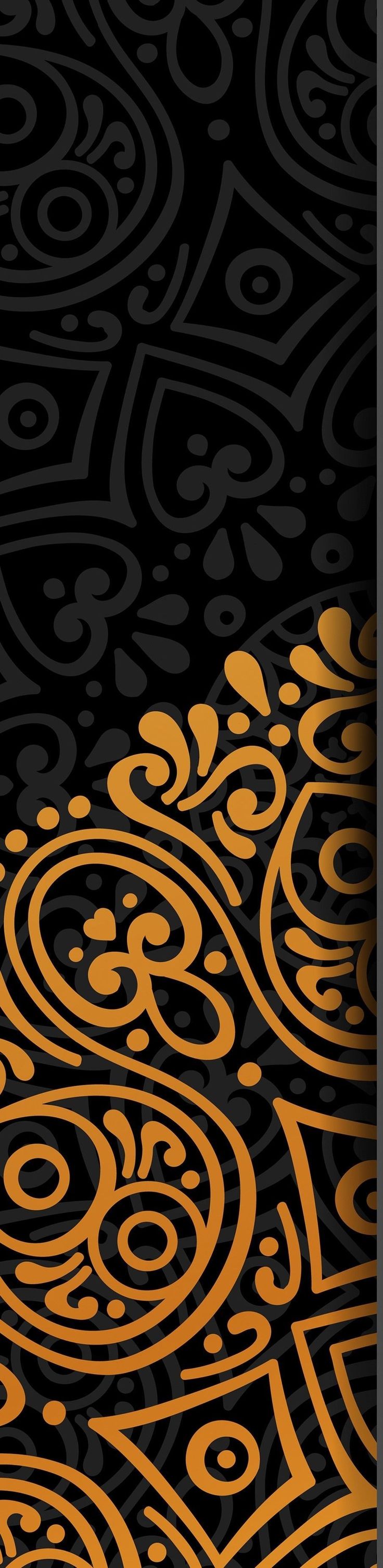 an abstract black and gold background with swirly circles in the center, on top of a dark surface