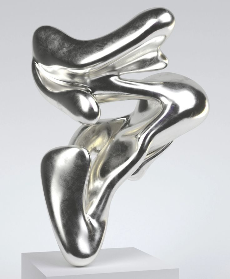 a silver sculpture is sitting on a white pedestal