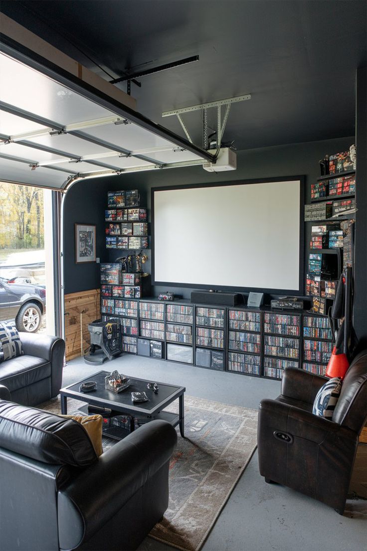 Man Cave Ideas in garage Garage To Hang Out Room, Living Room With Garage Door, Garage Entertainment Room, Black Man Cave Ideas, Turn Garage Into Man Cave, Man Space Ideas, Single Garage Conversion Ideas Uk, Cool Garage Ideas Hangout, Small Garage Hangout Ideas