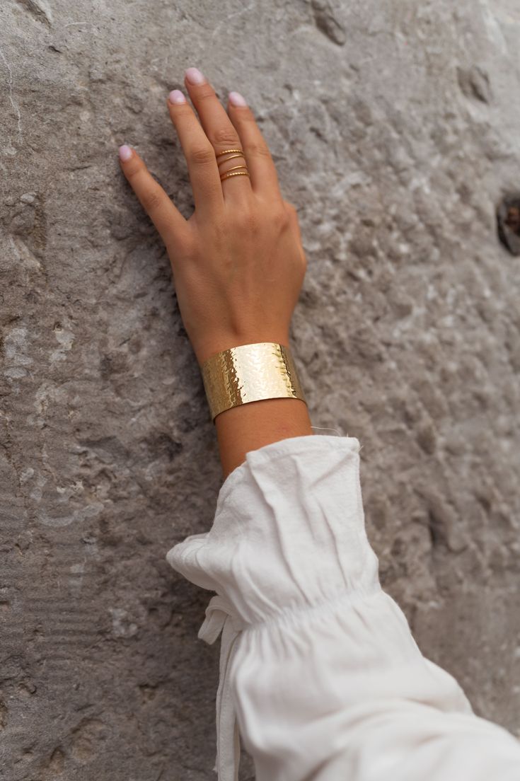 Our stainless steel Omar bracelet features a golden finish and a unique hammered effect. Perfect for adding a touch of luxury to any look. Parisian Summer, Summer Fashion, Stainless Steel, France, Bracelet, Ring, Fashion Design