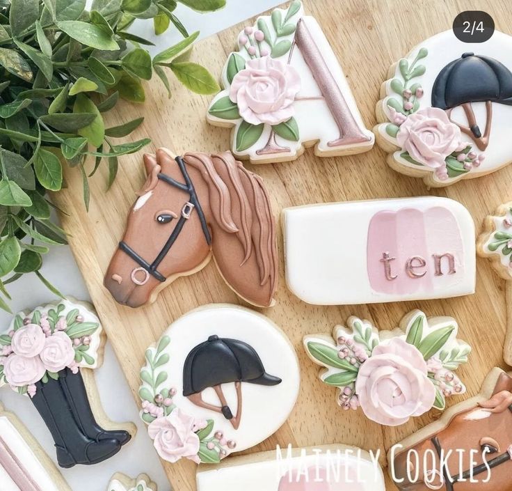 decorated cookies with horse and rider on them sitting on a table next to a potted plant