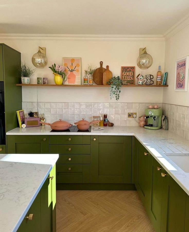 a kitchen with green cabinets and white counter tops