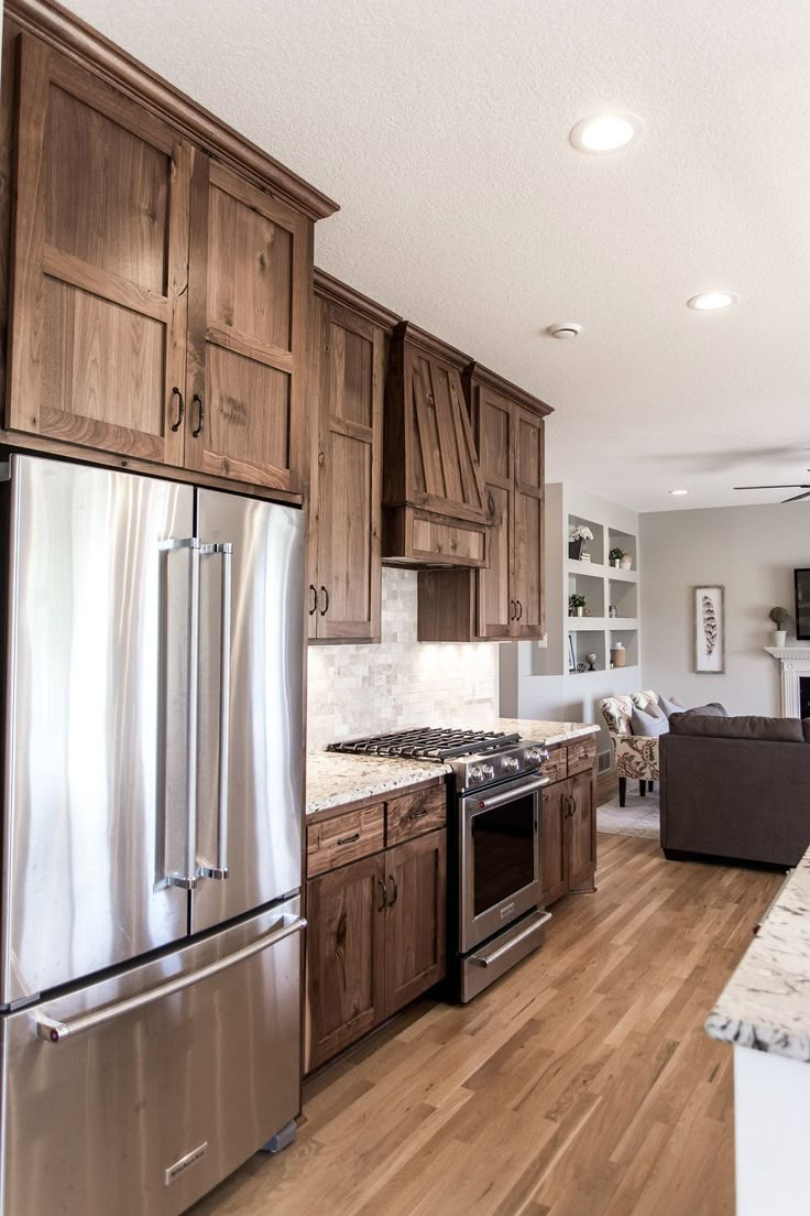 a kitchen with wooden cabinets and stainless steel appliances