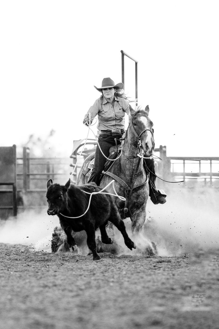 a man riding on the back of a horse next to a dog