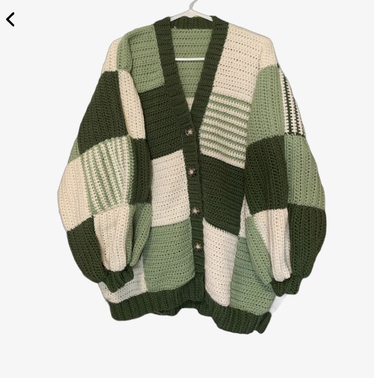 a green and white cardigan sweater hanging on a hanger with the words,