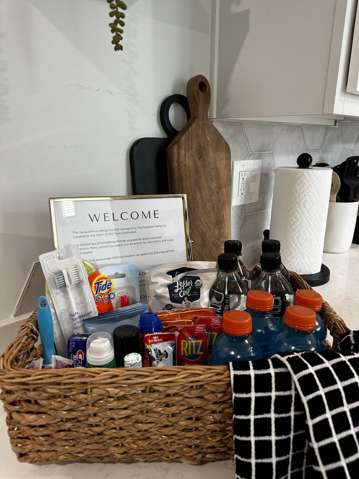 a basket filled with personal care items sitting on top of a counter next to a kitchen sink