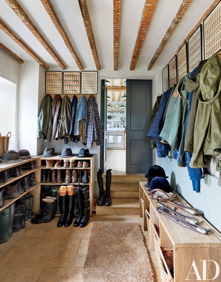 the inside of a shoe store with lots of shoes on shelves and clothes hanging up