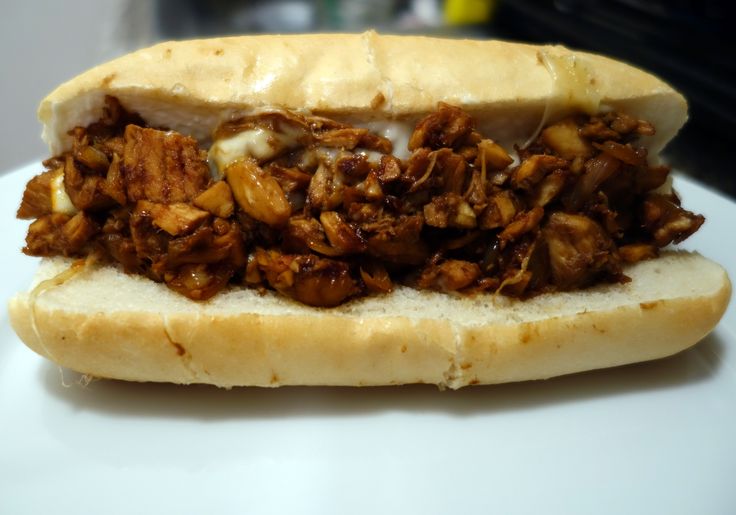 a sandwich with meat and onions on a bun