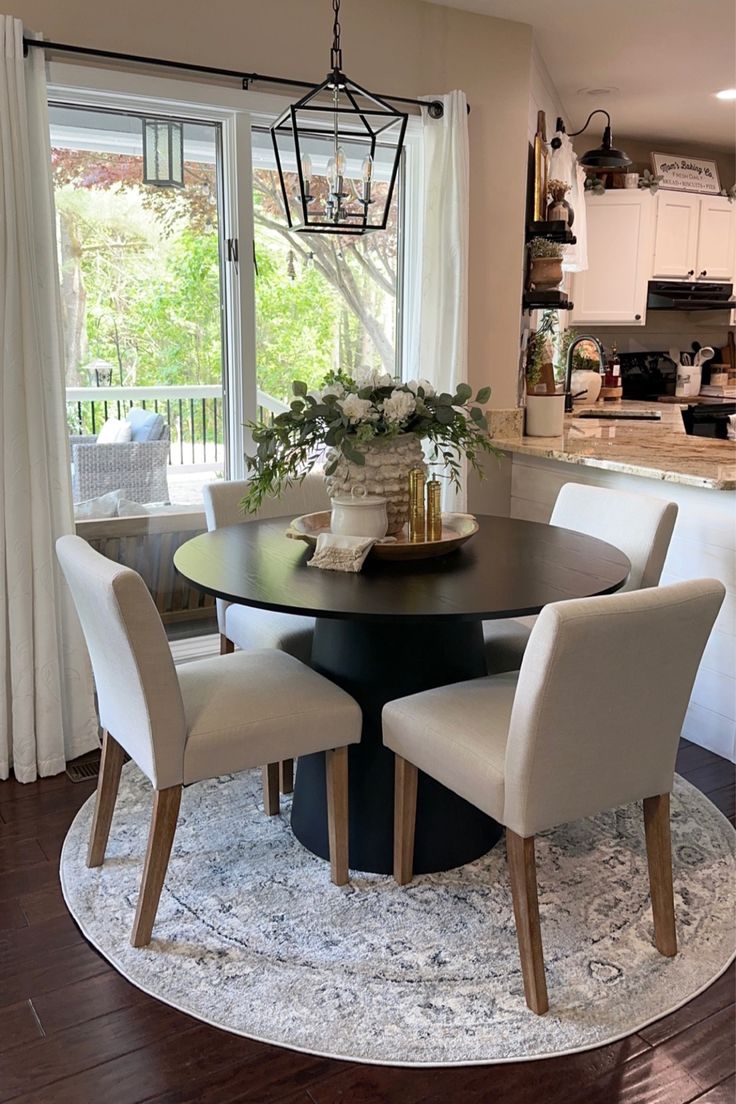 a dining room table with four chairs around it