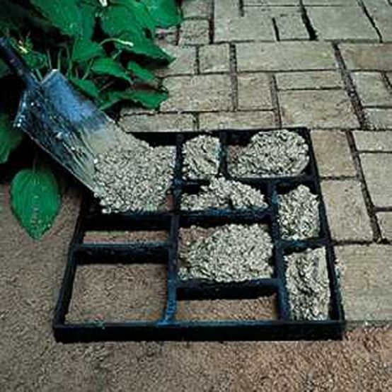 there is a square tray with gravel in it on the ground