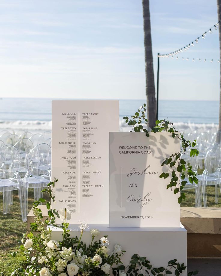 an outdoor ceremony setup with white flowers and greenery on the side, along with seating for guests