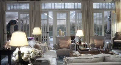 a living room filled with lots of furniture and lamps on top of it's windows